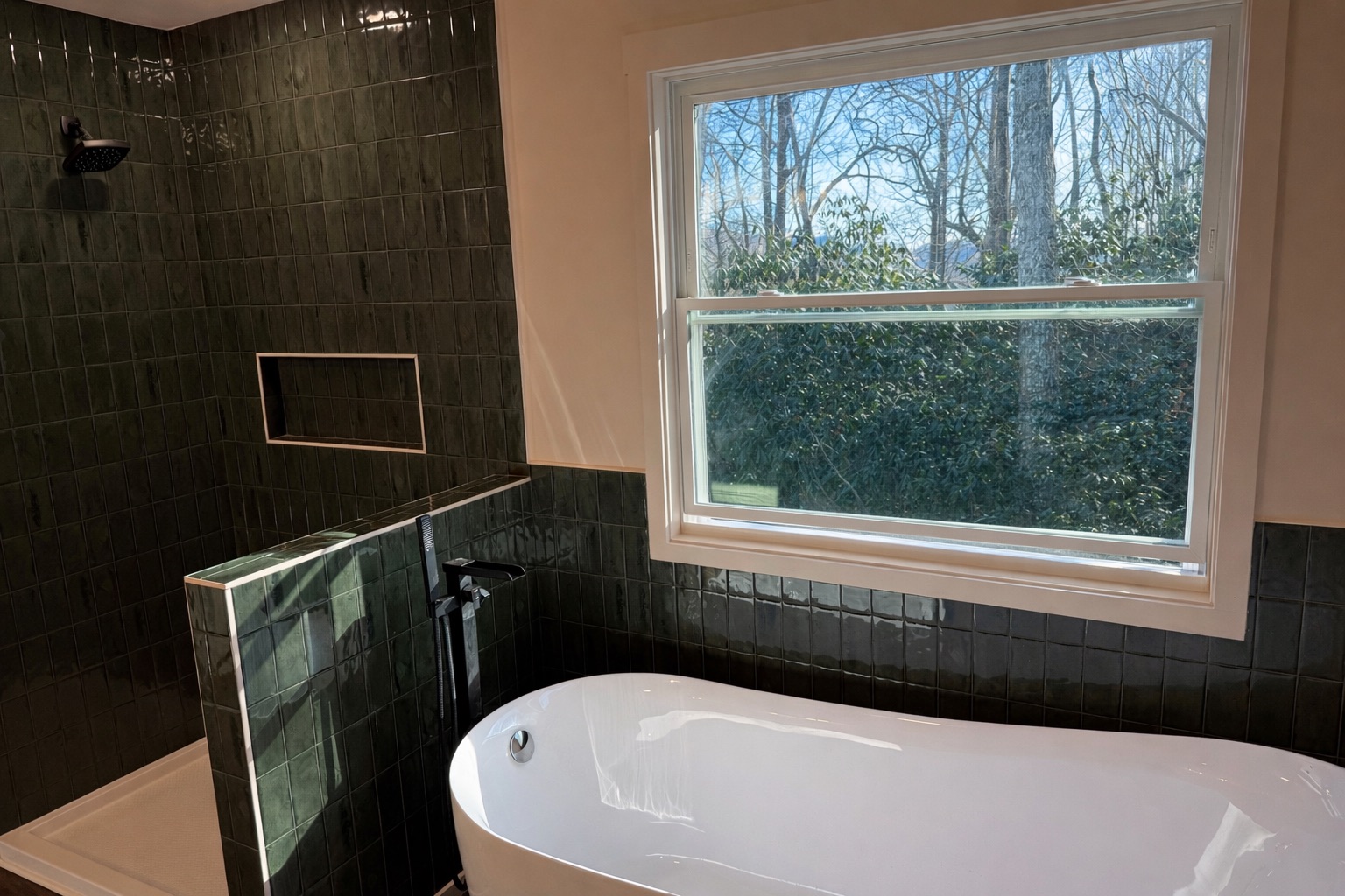 Forest green stacked tile master bath with freestanding tub and matte black tub filler in Upstate SC