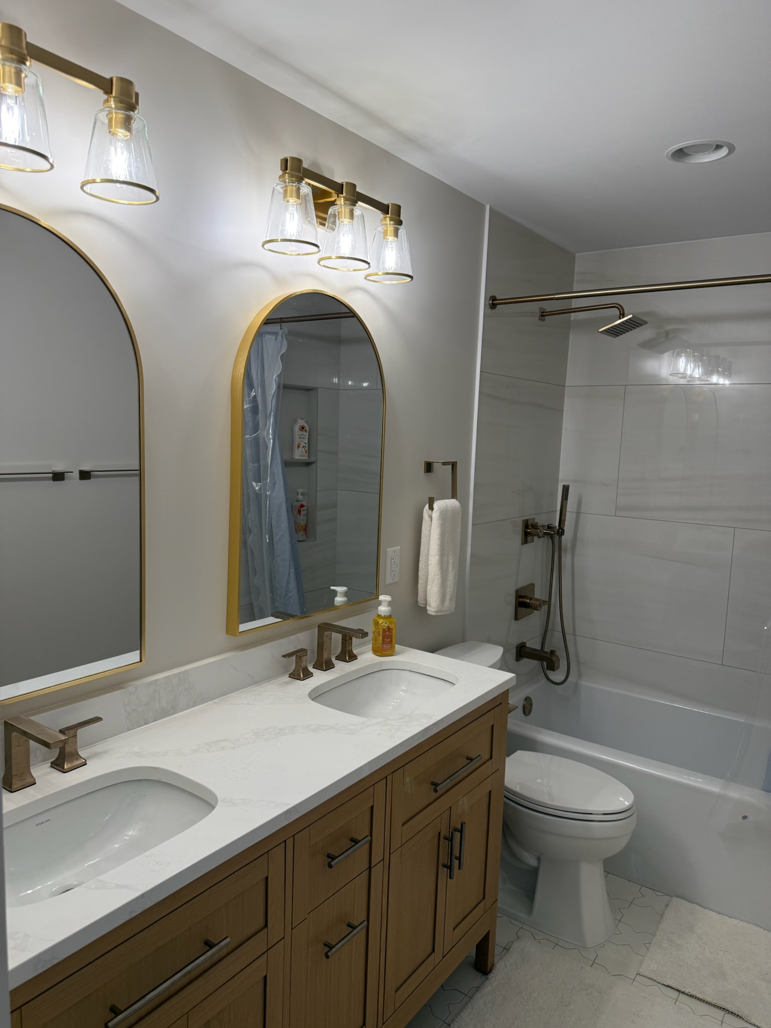Guest bathroom remodel in Simpsonville, SC with framed mirrors, vanity lighting, and updated fixtures - Ketner family photo 2