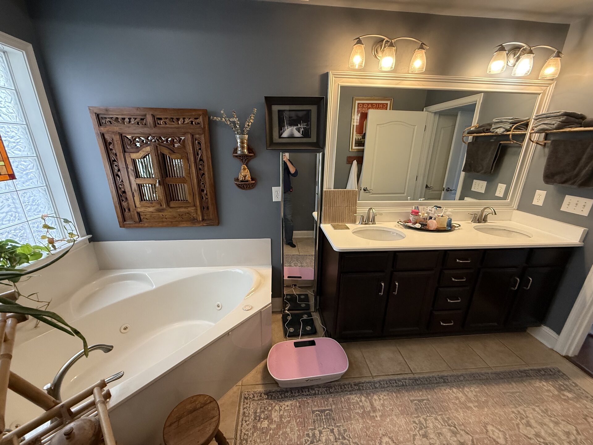 Before: original Verrilli primary bathroom in Greenville, SC with a corner whirlpool tub, builder-grade double vanity, and dated layout prior to the full reconfiguration