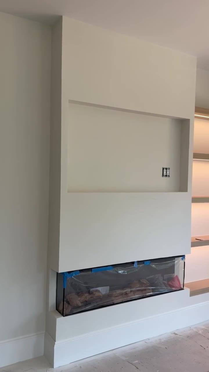 Linear fireplace feature wall with a recessed mounting bay above in a high-end Chesnee, SC build